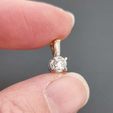 Load image into Gallery viewer, 18ct Yellow & White Gold Brilliant Cut and Baguette Cut Diamond Pendant in hand