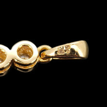 Load image into Gallery viewer, A close up on a yellow gold halter showing an 18ct gold hallmark and a maker's mark, on a black background