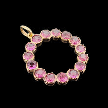 Load image into Gallery viewer, A circular yellow gold pendant with almandine garnets, on a black background