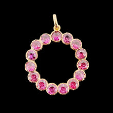 Load image into Gallery viewer, A circular yellow gold pendant with almandine garnets, on a black background
