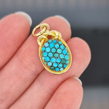 Load image into Gallery viewer, Victorian 18ct Yellow Gold Turquoise Pavé Pendant held in the hand with a dark background