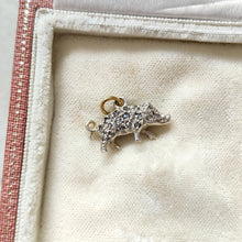 Load image into Gallery viewer, A diamond and ruby set silver pig charm with a gold jump ring, in an antique box