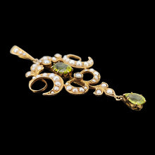 Load image into Gallery viewer, A peridot and pearl Art Nouveau style pendant in yellow gold, on a black background