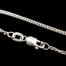 Load image into Gallery viewer, A close-up of a white gold curb link chain with a lobster claw clasp, on a black background