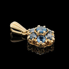 Load image into Gallery viewer, A yellow gold pendant with seven round sapphires, on a black background