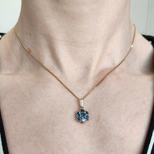 Load image into Gallery viewer, A yellow gold pendant with seven round sapphires, modelled around a neck with a gold chain