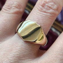 Load image into Gallery viewer, A yellow gold shield shaped signet ring, modelled on a hand