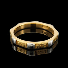 Load image into Gallery viewer, An eight sided band ring in gold and platinum with floral engraving, on a black background