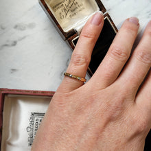 Load image into Gallery viewer, An eight sided band ring in gold and platinum with floral engraving, modelled on a little finger