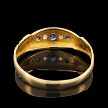 Load image into Gallery viewer, A yellow gold five stone sapphire and diamond ring, on a black background
