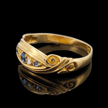 Load image into Gallery viewer, A yellow gold five stone sapphire and diamond ring, on a black background