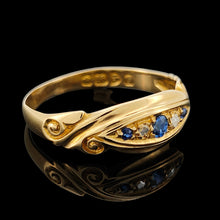 Load image into Gallery viewer, A yellow gold five stone sapphire and diamond ring, on a black background
