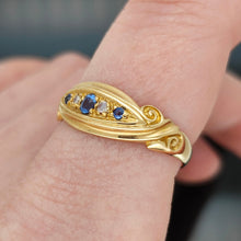 Load image into Gallery viewer, A yellow gold five stone sapphire and diamond ring, modelled on a hand