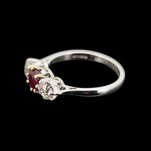 Load image into Gallery viewer, A ruby and diamond three stone ring on a black background