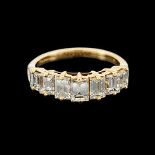 Load image into Gallery viewer, A seven stone baguette cut diamond graduated ring in yellow gold, on a black background