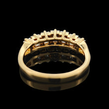 Load image into Gallery viewer, A seven stone baguette cut diamond graduated ring in yellow gold on a black background