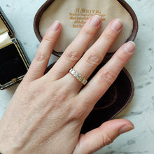 Load image into Gallery viewer, A seven stone baguette cut diamond graduated ring in yellow gold, modelled on a hand