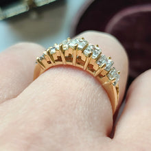Load image into Gallery viewer, A seven stone baguette cut diamond graduated ring in yellow gold, modelled on a hand