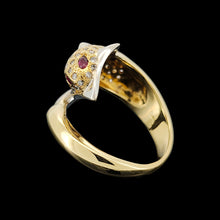 Load image into Gallery viewer, A yellow and white gold dolphin ring with diamonds and ruby eyes, on a black background