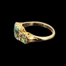 Load image into Gallery viewer, Gold ring with emeralds and diamonds on a black background