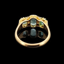 Load image into Gallery viewer, Gold ring with emeralds and diamonds, viewed from behind, on a black background