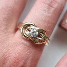 Load image into Gallery viewer, Gold ring with a diamond on a finger against a neutral background