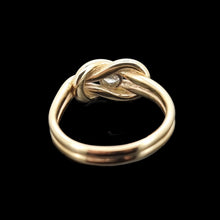 Load image into Gallery viewer, Gold knot ring with a diamond on a black background