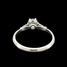 Load image into Gallery viewer, A diamond solitaire ring in platinum, on a black background