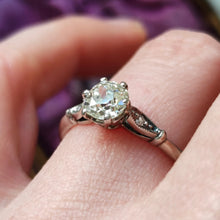 Load image into Gallery viewer, A diamond solitaire ring in platinum, modelled on a hand