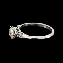 Load image into Gallery viewer, A diamond solitaire ring in platinum, on a black background
