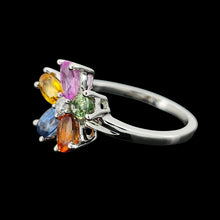 Load image into Gallery viewer, A multi-coloured gemstone flower shaped ring in white gold, on a black background