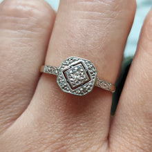 Load image into Gallery viewer, An octagonal shaped diamond ring in yellow gold and platinum, modelled on a hand