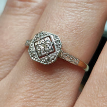 Load image into Gallery viewer, An octagonal shaped diamond ring in yellow gold and platinum, modelled on a hand
