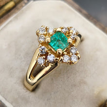 Load image into Gallery viewer, An emerald and diamond compass set cluster ring in yellow gold with split shoulders, in an antique ring box