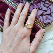 Load image into Gallery viewer, A gold hexagonal shaped signet ring, modelled on a hand
