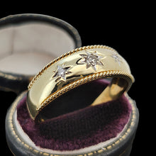 Load image into Gallery viewer, A three stone diamond star set gypsy ring in yellow gold, in a ring box, on a black background