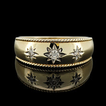 Load image into Gallery viewer, A three stone diamond star set gypsy ring in yellow gold, on a black background