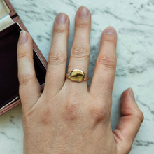 Load image into Gallery viewer, A yellow gold and platinum signet ring, modelled on a hand