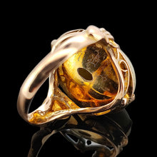 Load image into Gallery viewer, An oval, cabochon green agate dress ring in yellow gold, on a black background