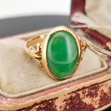 Load image into Gallery viewer, An oval shaped green jade ring in yellow gold, in an antique ring box