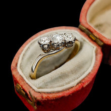Load image into Gallery viewer, A three stone diamond trilogy ring in yellow gold and platinum, in a ring box, on a black background