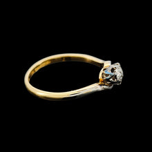 Load image into Gallery viewer, A three stone diamond trilogy ring in yellow gold and platinum, on a black background