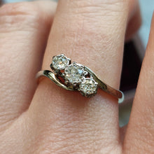 Load image into Gallery viewer, A three stone diamond trilogy ring in yellow gold and platinum, modelled on a hand