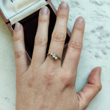 Load image into Gallery viewer, A three stone diamond trilogy ring in yellow gold and platinum, modelled on a hand