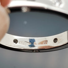 Load image into Gallery viewer, A close-up of a 750 stamp and an Italian stamp inside a white gold ring shank