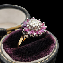 Load image into Gallery viewer, A circular ruby and diamond cluster ring in yellow and white gold, in a ring box, on a black background