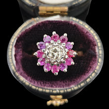 Load image into Gallery viewer, A circular ruby and diamond cluster ring in yellow and white gold, in a ring box, on a black background