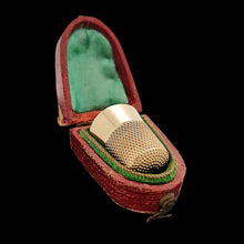 Load image into Gallery viewer, A yellow gold thimble in a red and green antique fitted box, on a black background