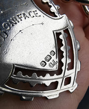 Load image into Gallery viewer, A silver Albert watch chain with large oval links, two lobster clasps, a T-bar and a shield shaped fob medal, held in a hand