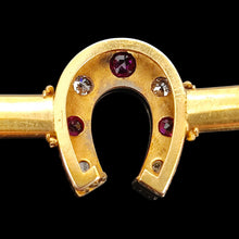 Load image into Gallery viewer, Close-up of a yellow gold horseshoe bangle bracelet with rubies and diamonds, on a black background
